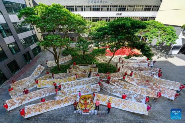 Ντόπιοι καλλιτέχνες και λάτρεις της ζωγραφικής παρουσιάζουν πίνακες τίγρης κατά τη διάρκεια μιας έκθεσης στο Κλανγκ του Σελανγκόρ στην Μαλαισία, 16 Ιανουαρίου 2022. (Φωτογραφία Chong Voon Chung/Xinhua) 